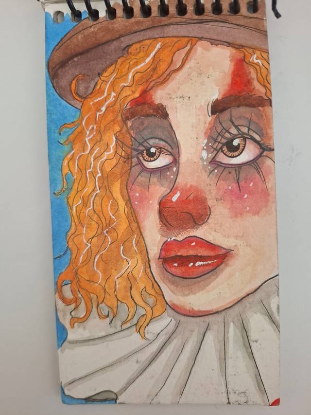 Watercolor portrait of a clown with orange curly hair, a red nose, painted cheeks and a ruffled collar on a blue background.