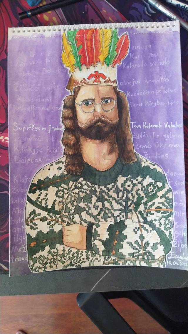 Watercolor and ink portrait of a bearded man with glasses wearing a feathered headdress and a patterned green sweater, on a purple background covered in handwriting.