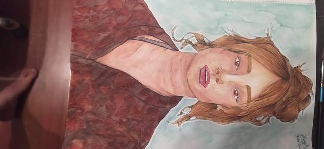 Watercolor portrait of a person with long auburn hair against a dark red patterned background.