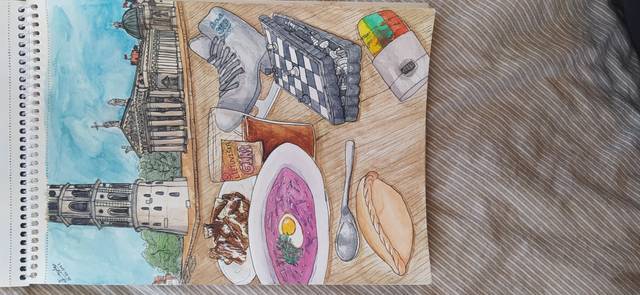 Ink and watercolor sketchbook spread of a meal with a bowl of soup, bread, tea and salad, beside a small drawing of a church tower.