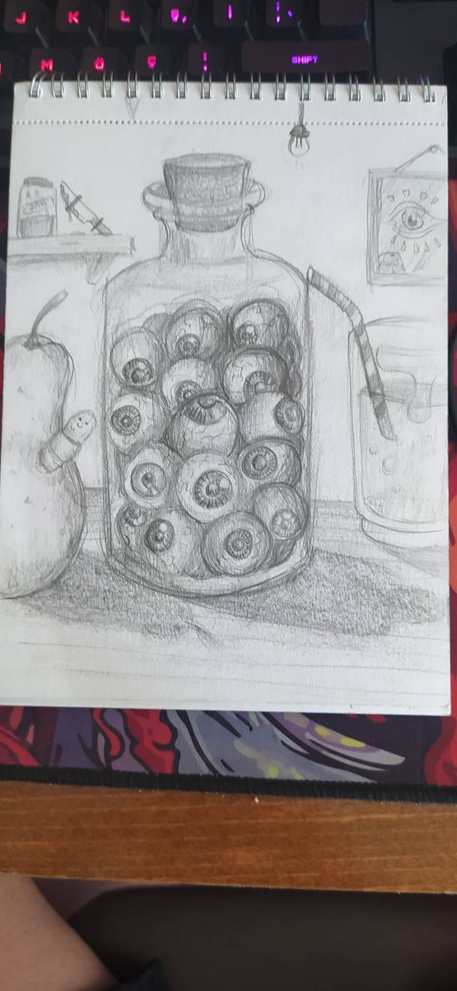 Graphite still life of a glass jar filled with eyeballs beside a pear and a drinking glass, on a spiral pad.