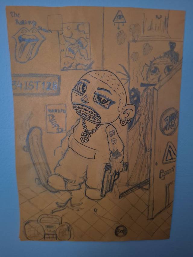 Blue ballpoint pen sketch on brown cardboard of a cartoon bald figure with a cigarette and a bag, surrounded by posters, a skateboard and a boombox.